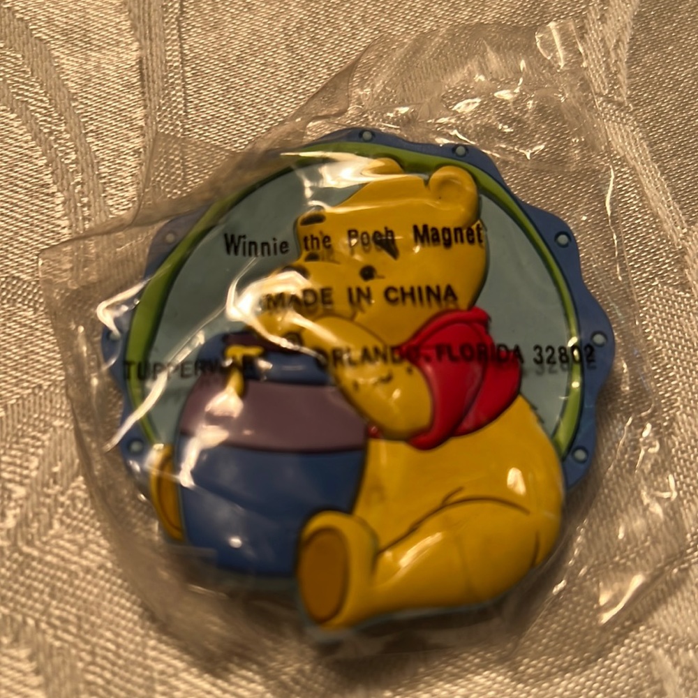 Winnie the Pooh Tupperware magnet.  New in package